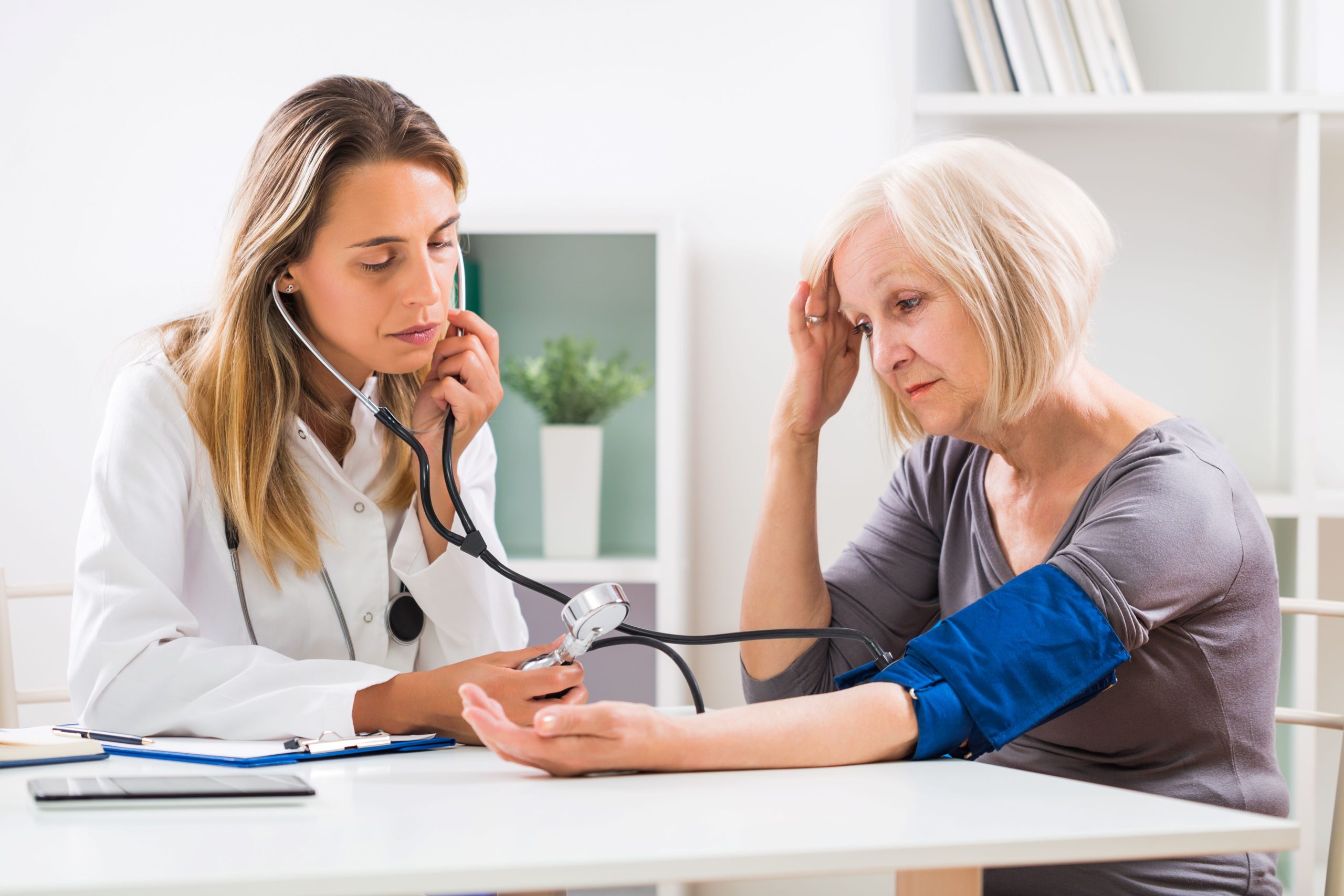 mature woman in midlife consulting a doctor, diagnosis: mineral deficiency