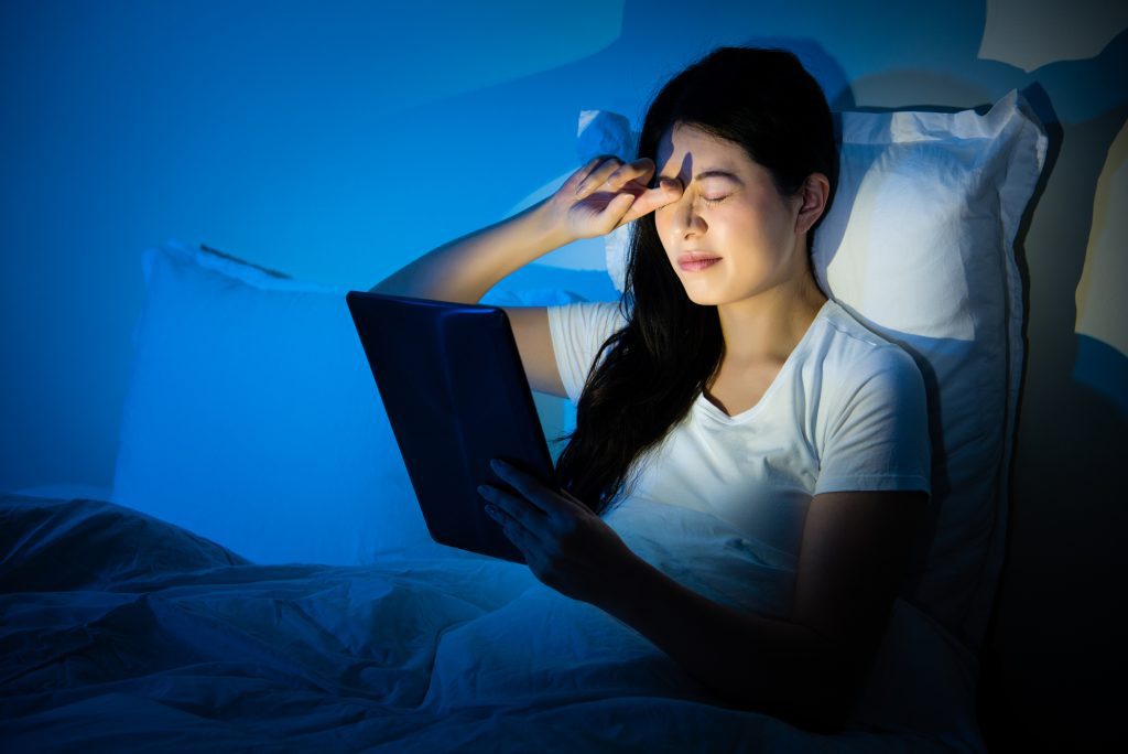 Woman with eye strain due to the effects of blue light.