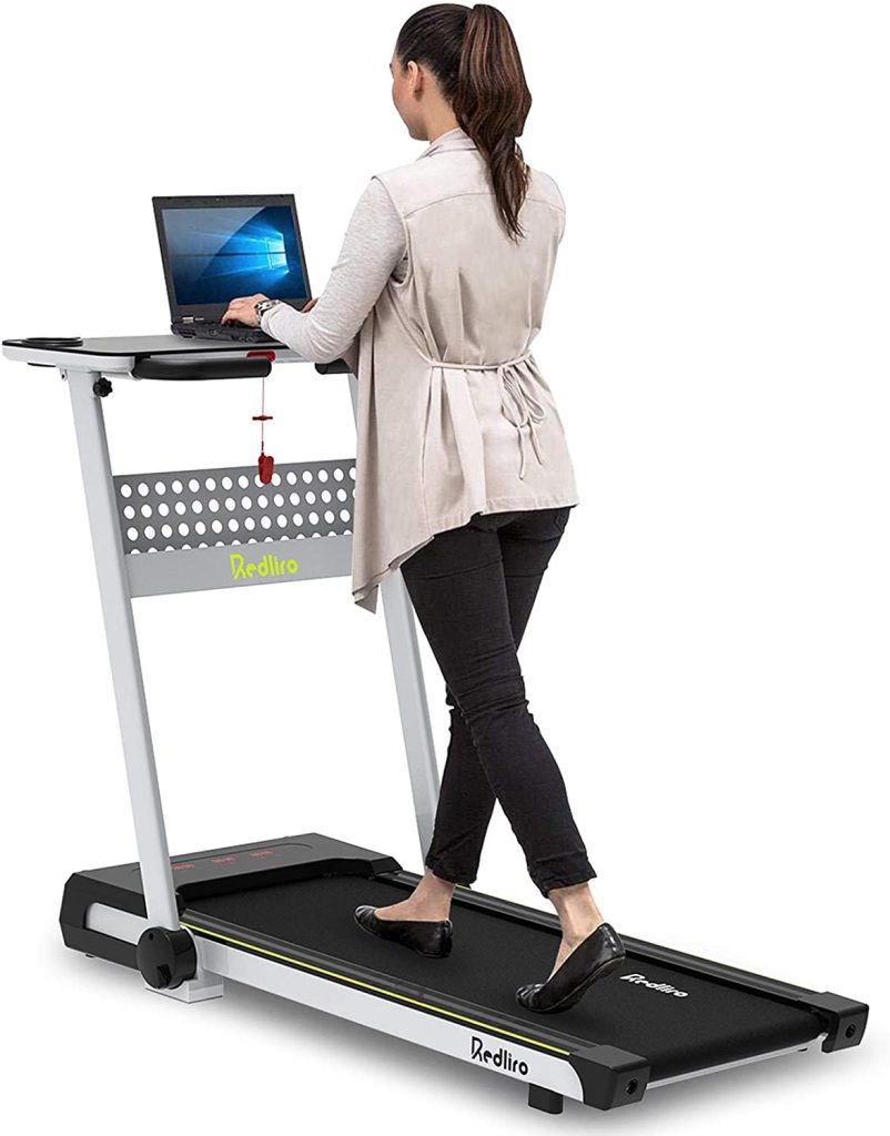 Woman using a treadmill desk as a best immune booster activity.
