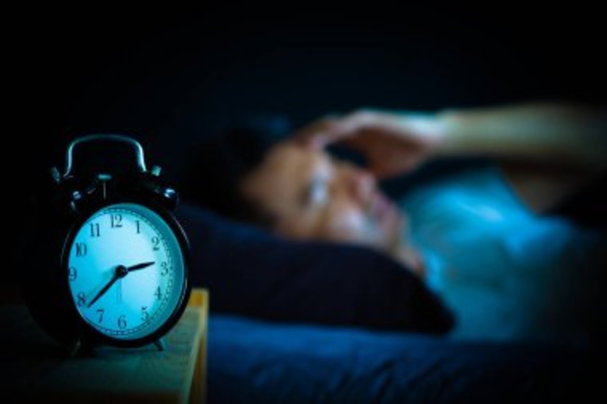 A man struggling to fall asleep.