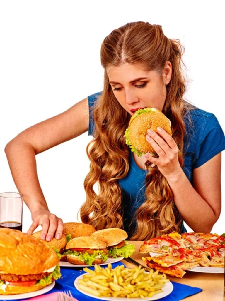 Women indulging in fast food highlights potential toxins.