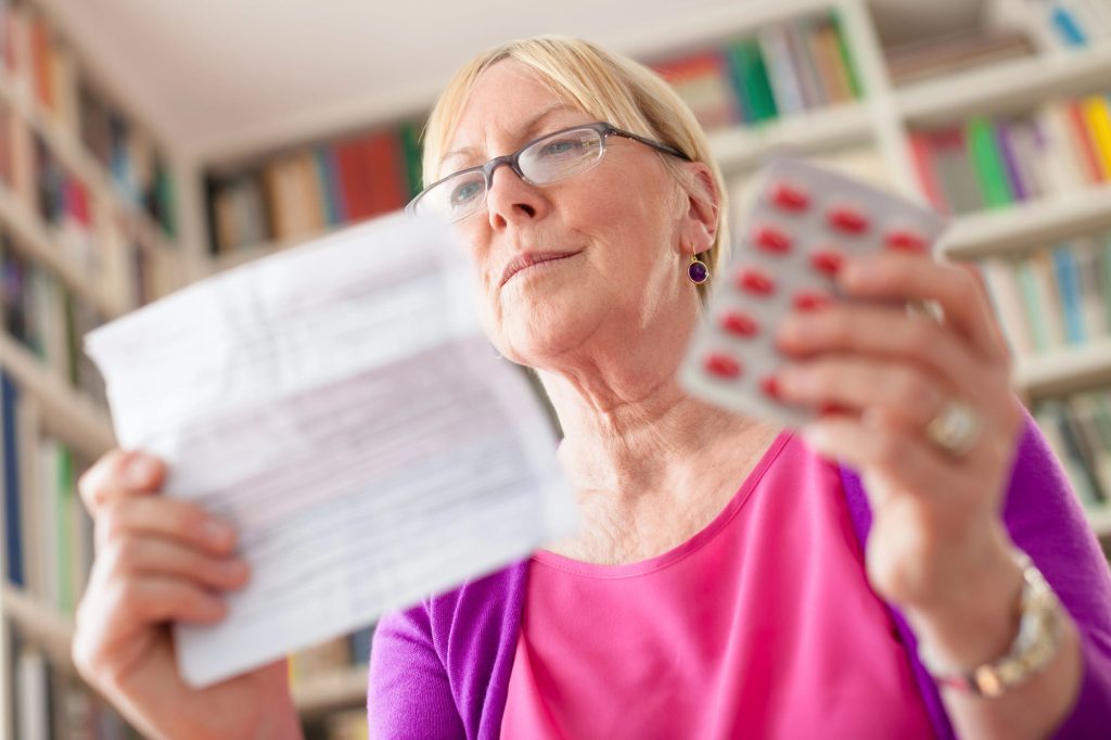 Woman taking medication for headaches.