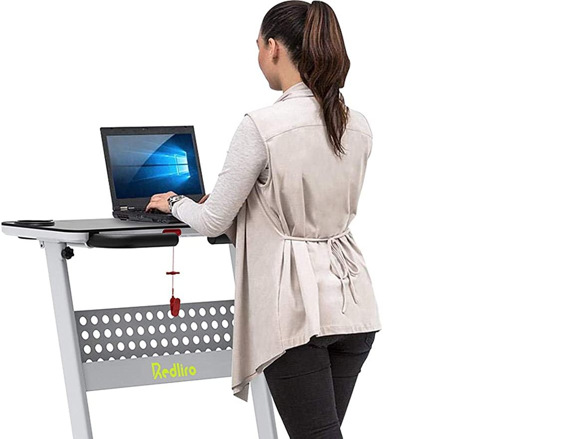 Woman using a treadmill desk as a best immune booster activity.