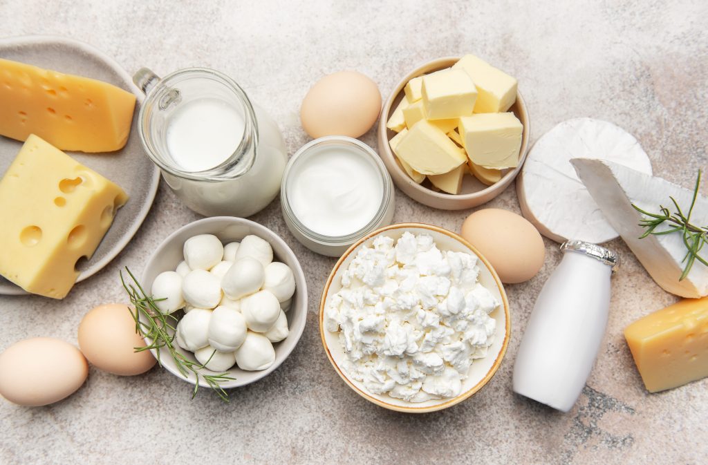 Assortment of milk and fat products ranging from whole milk to cheese and eggs