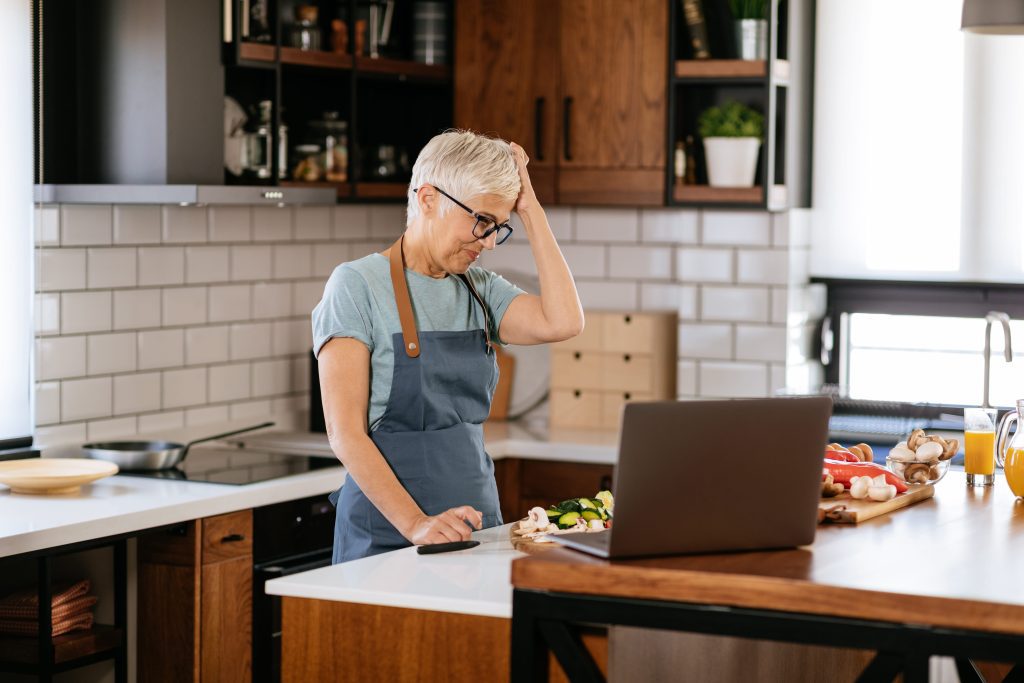Senior woman frustrated through perimenopause rage in kitchen